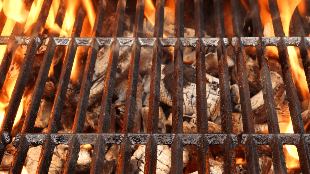 Grill grate with hot coals beneath